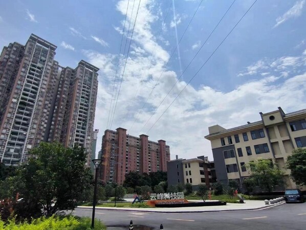 A residential area with high-rise buildings, a road, and a sign for YUNFENG SCIENCE PARK.