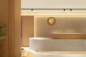 A modern reception area with a circular sign, a reception desk, and a plant. - Ji Guangzhou Liwan TCL Yunfeng Technology Park (Guangzhou)