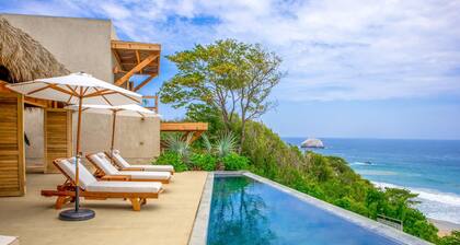 Spacious beachside home with pool, tropical garden, and oceanview lounging