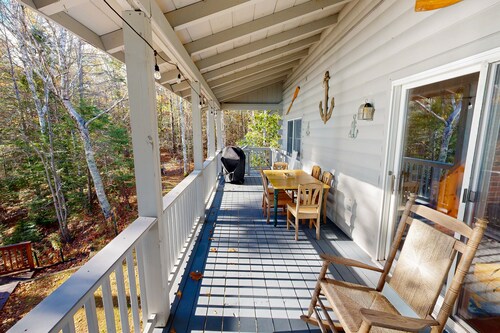 Charming riverfront home with cozy interiors, dock, and scenic deck views