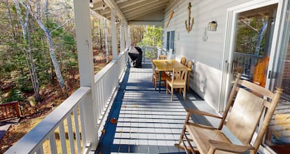 Charming riverfront home with cozy interiors, dock, and scenic deck views