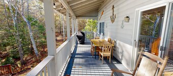 Charming riverfront home with cozy interiors, dock, and scenic deck views