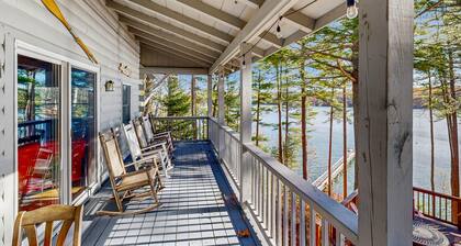 Charming riverfront home with cozy interiors, dock, and scenic deck views