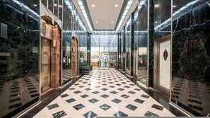 A modern hotel lobby with a checkered floor, glass doors, and marble walls. - Luxury Downtown Phoenix Loft - Pool Gym Laundry (Phoenix)