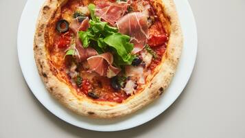 A pizza with toppings on a white plate.