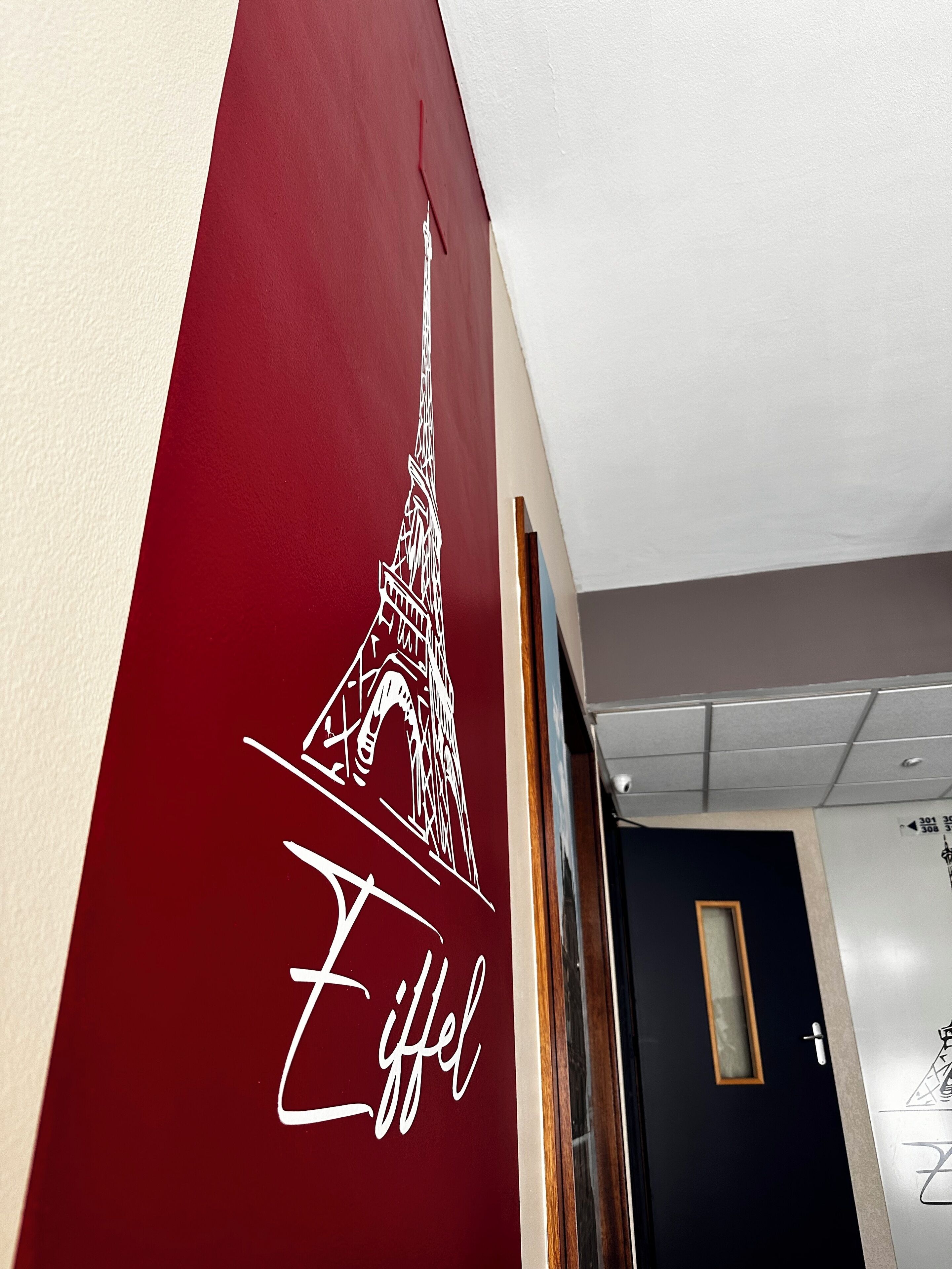 A wall with a red section featuring a white Eiffel Tower illustration and the word "Eiffel".