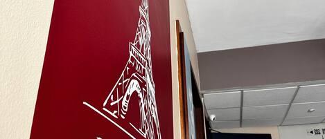 A wall with a red section featuring a white Eiffel Tower illustration and the word "Eiffel".