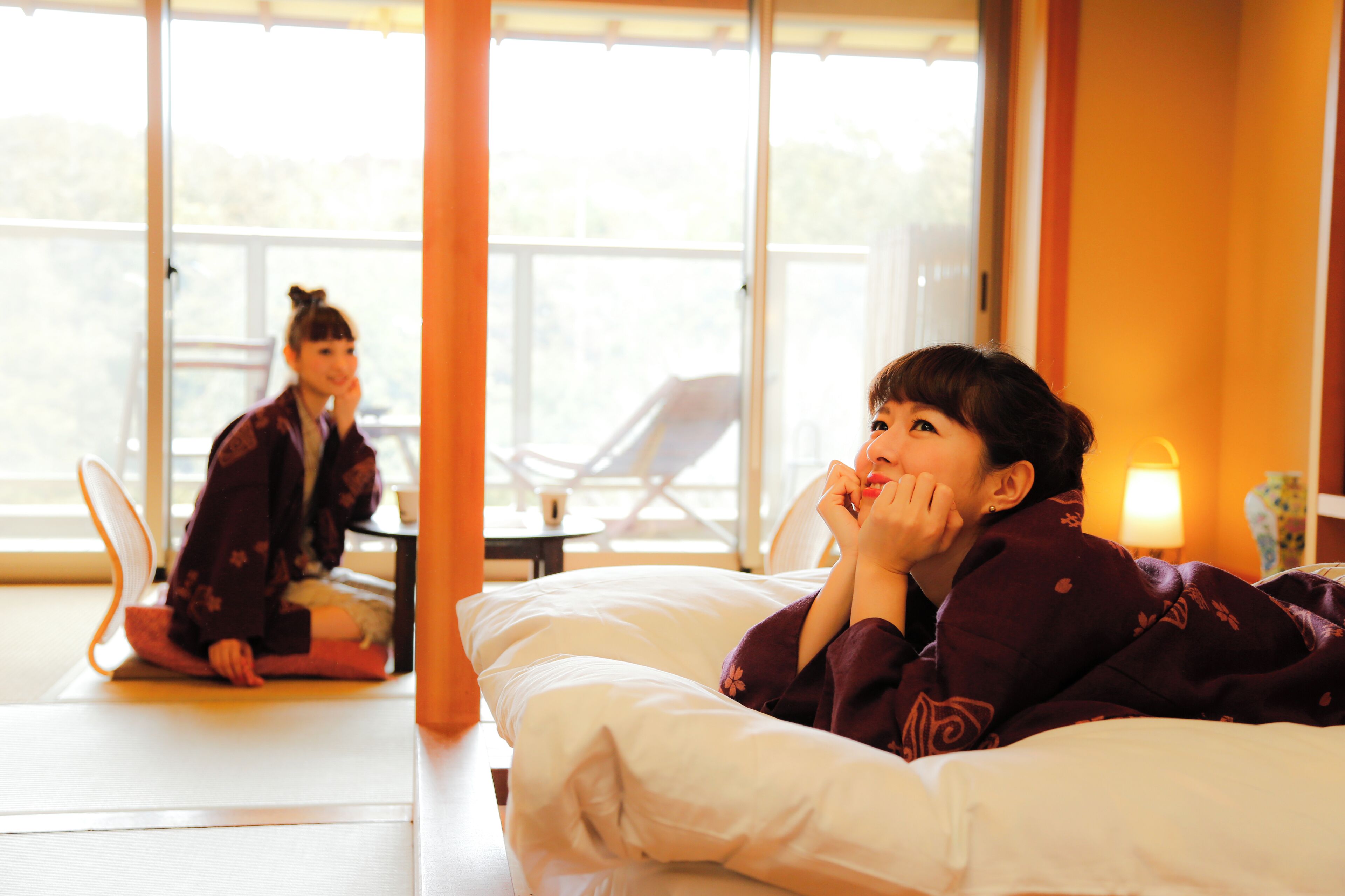 A room with a bed, a chair, and a table.