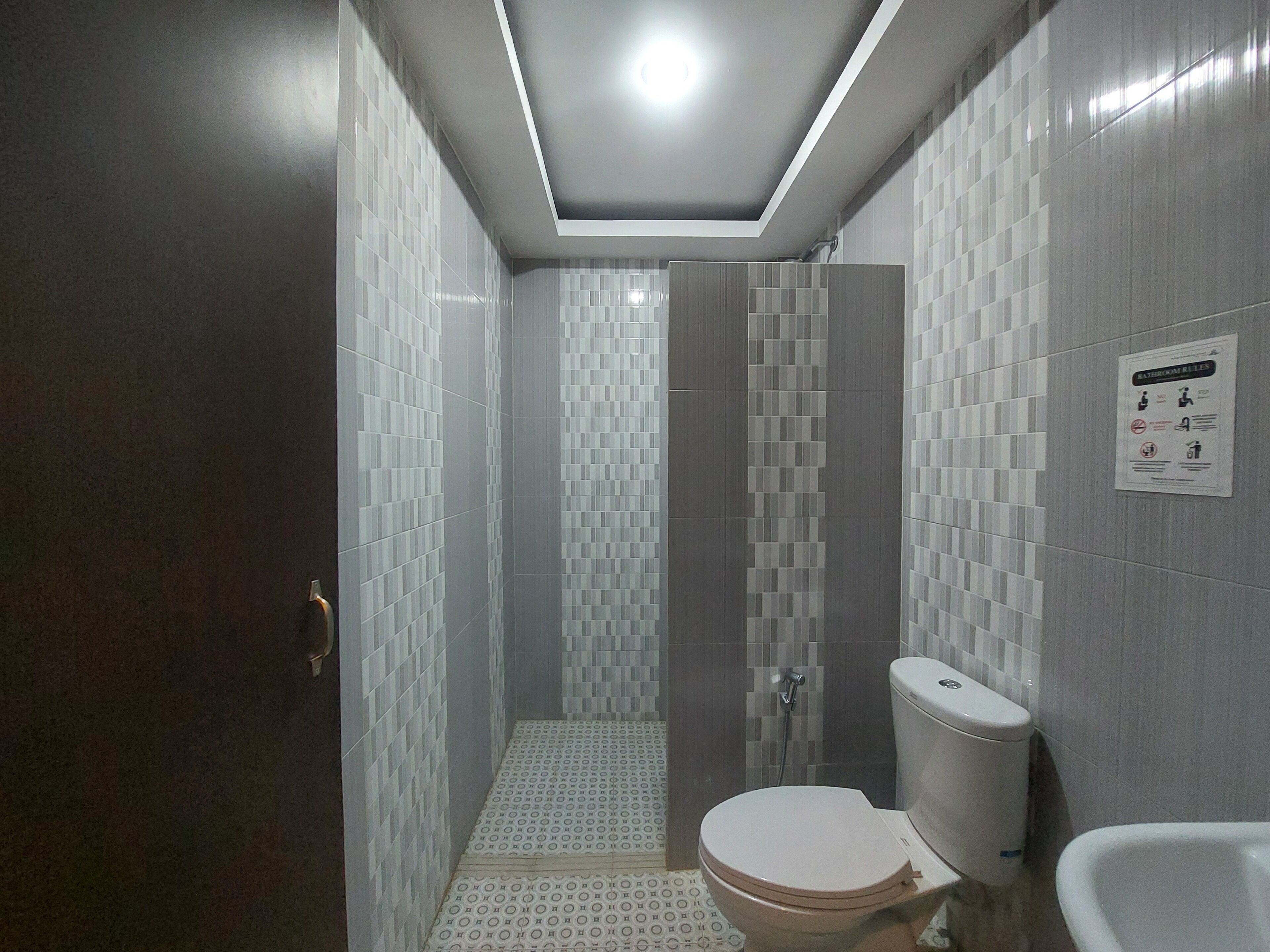 A bathroom with a toilet, bidet, and shower area.