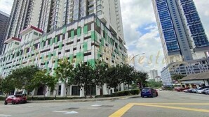A multi-story building with a modern architectural design, featuring a mix of white and green facade panels. - Twin Galaxy (Johor Bahru)