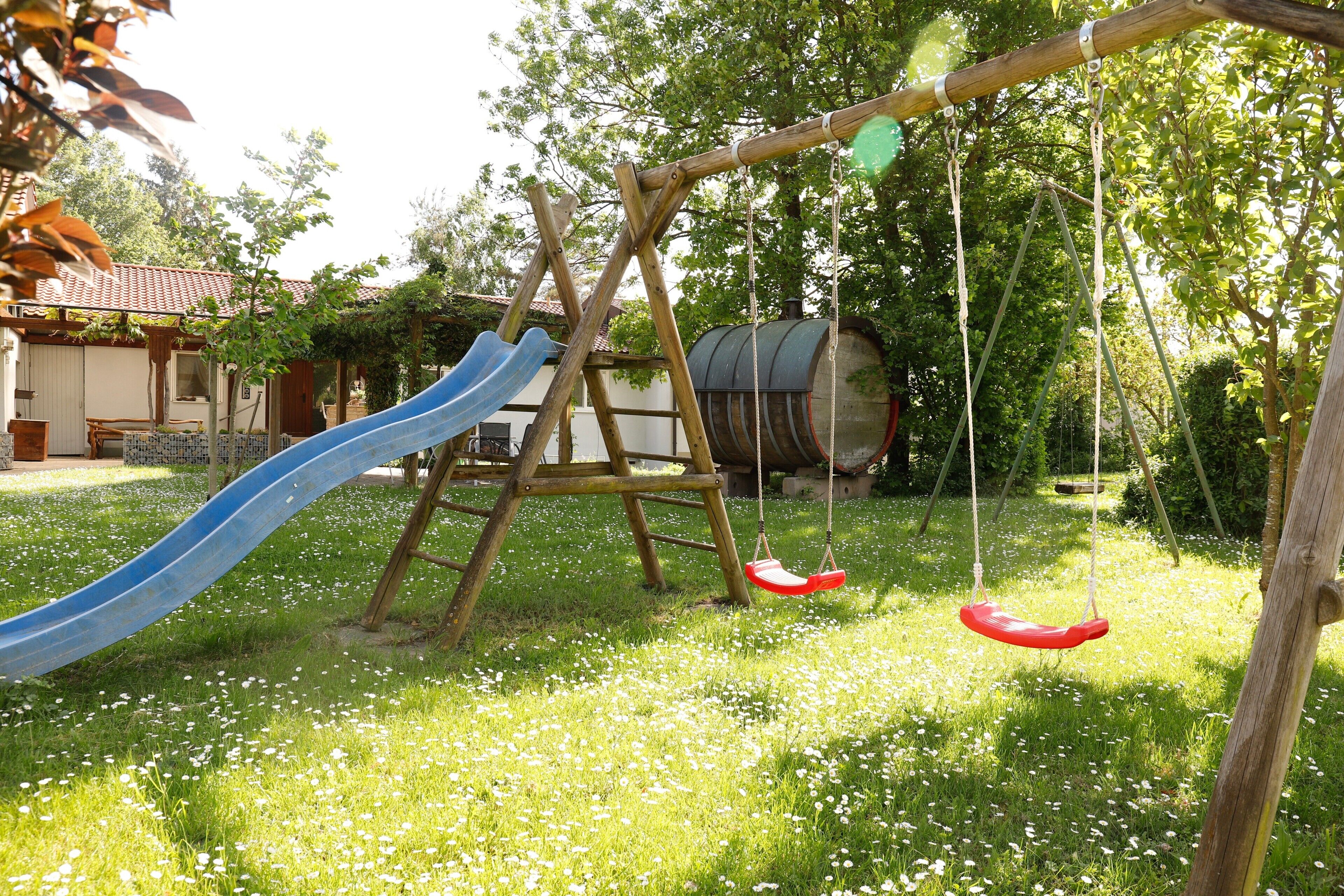 Ein Spielplatz mit Rutsche und Schaukeln.