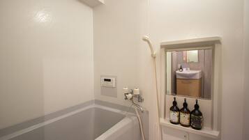 Combined shower/bathtub, hair dryer, bathrobes, slippers