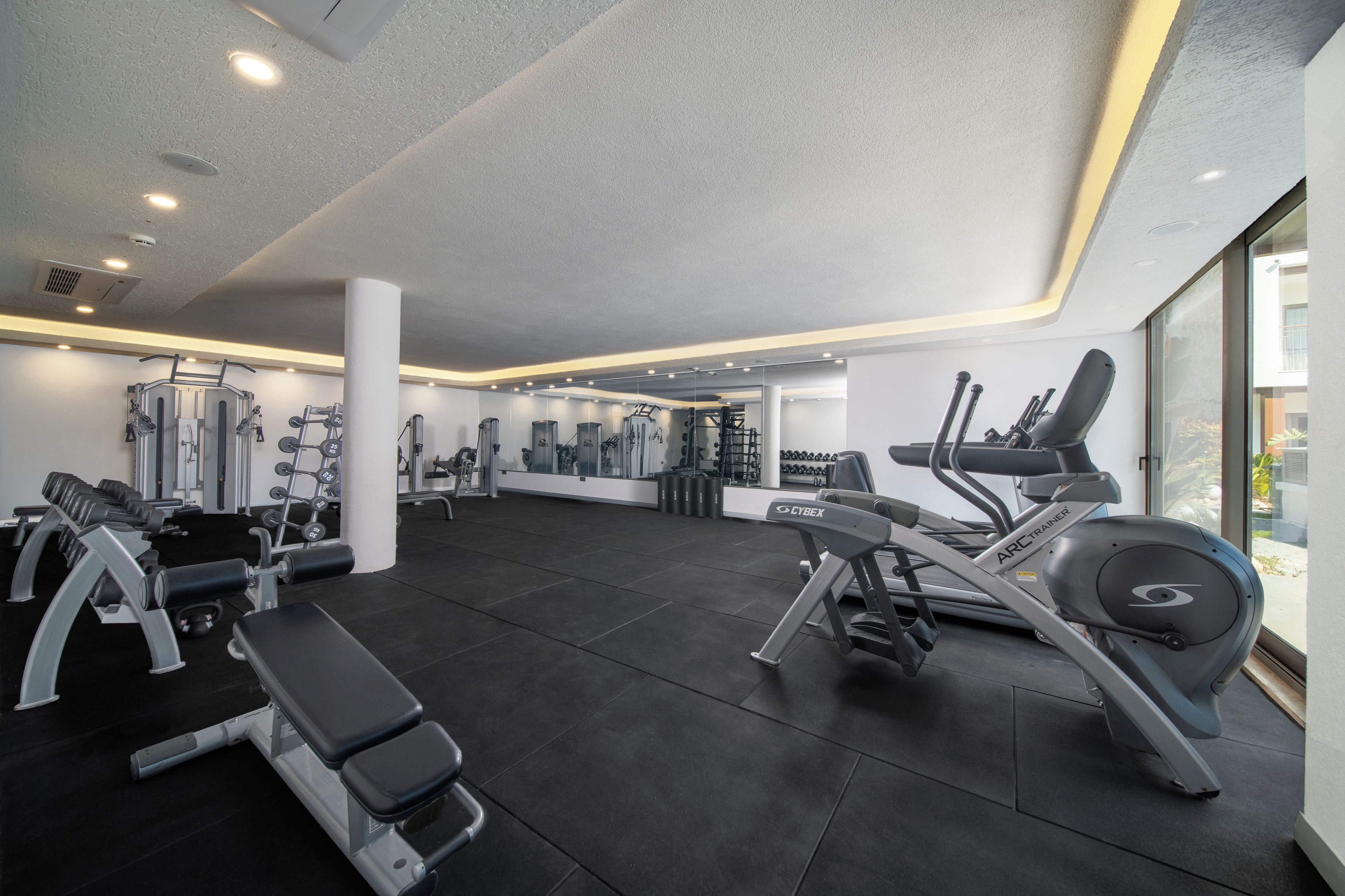 A gym with various exercise equipment, including treadmills and weight machines.