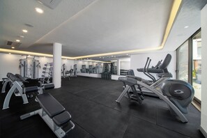 A gym with various exercise equipment, including treadmills and weight machines. - Ayaz Suites (Bodrum)