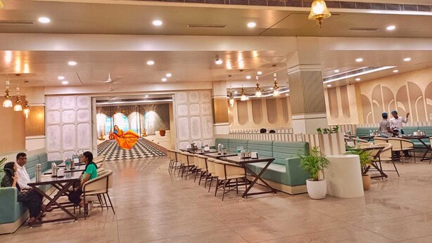 A spacious hotel lobby with seating areas, a checkered floor, and a central decorative element. - THE PRINCE ZENQ XPRESS RESORTT ROHTAK (Sampla)