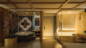 A modern bathroom with a freestanding bathtub, a large mirror, and a wooden floor.