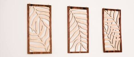 Three wooden panels with leaf patterns.