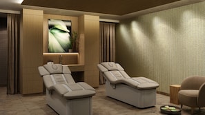 A spa room with two massage chairs, a wooden cabinet, a sink, and a textured wall. - Nature Resort Jakobsberg (Boppard)