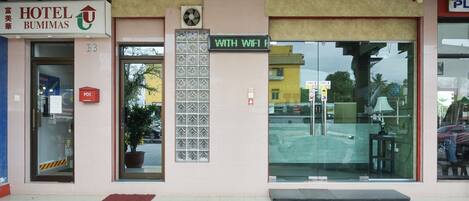 The entrance of Hotel Bumimas with a sign indicating WiFi availability.