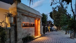 A building with a sign reading "PADINI'S" and a wooden door. - Padinis Villa & Coffee (Sukawati)