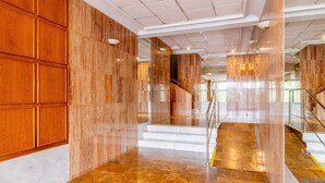 A spacious lobby with marble flooring, wooden paneling, and a staircase. - Bright Penthouse with Views in Calpe (Calpe)