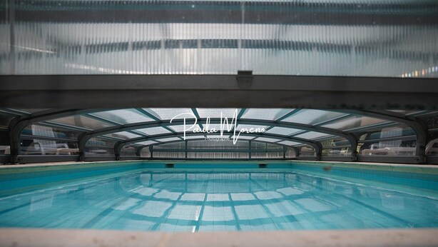 An indoor swimming pool with a glass ceiling, surrounded by walls and a poolside area. - Winery Cottage on a Vineyard Estate, Pellerin (Montbrison sur Lez)