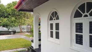 A white building with arched windows and a covered porch. - BEDBOX (Dambulla,)