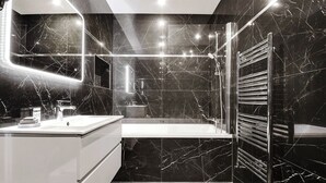 A modern bathroom with a marble floor, a white sink, and a glass-enclosed shower. - Modern Apartment - 2br/8p - Near Opera Garnier (Paris)