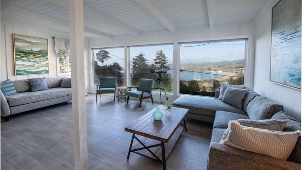 A modern living room with a sofa, a coffee table, and a view of the outdoors. - Coastal Charm - Oceanview Stay in Pacifica Near SF (Pacifica)