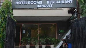 A hotel named "HELLO STAYZ" with a sign indicating it offers hotel rooms, a restaurant, and a banquet.