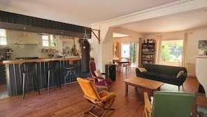 A spacious living area with a kitchen, dining area, and a cozy seating arrangement. - Villa Esterel, for 14 people, located 200 m from the beach (La Faute sur Mer)