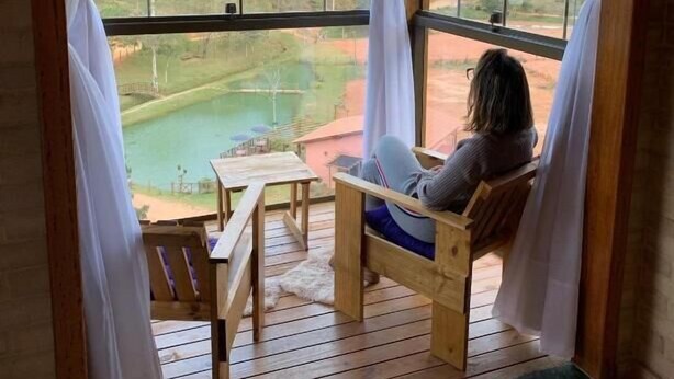 Eine Holzterrasse mit Blick auf einen See und Wald.