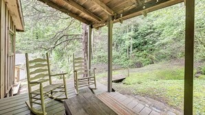A wooden porch with two rocking chairs and a bench, overlooking a forested area. - Trail Access & Tranquil Setting: Franklin Retreat! (Franklin)