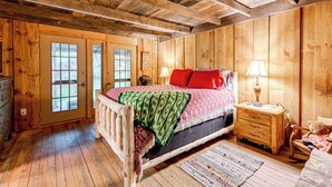 A wooden room with a bed, a nightstand, a chair, and a dresser. - Trail Access & Tranquil Setting: Franklin Retreat! (Franklin)