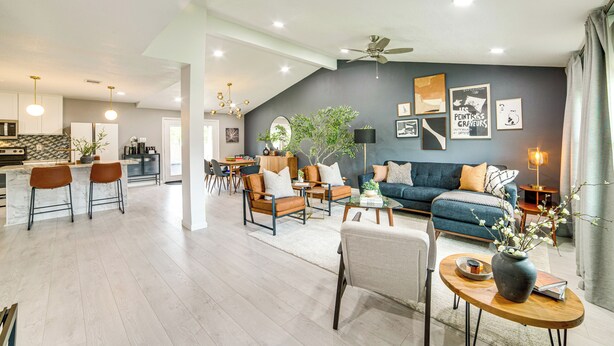 A spacious living area with a sofa set, a coffee table, and a dining area with chairs. - Spacious Family Home, 5 Mi to Galleria Dallas! (Carrollton)