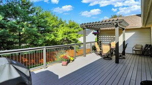 A wooden deck with a pergola, outdoor furniture, and potted plants. - Spacious Fishers 3BR, Walk to Park + Fishers District (Fishers)