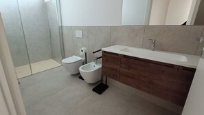 Regadera, secadora de cabello, bidet, toallas