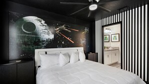 A modern bedroom with a large bed, a ceiling fan, and a wall mural featuring a space theme. - Cdw9161 (Four Corners)