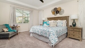 A bedroom with a bed, nightstands, a dresser, a window with blinds, and a decorative wall piece. - Solara Resort Vacation Home 5BR (Kissimmee)