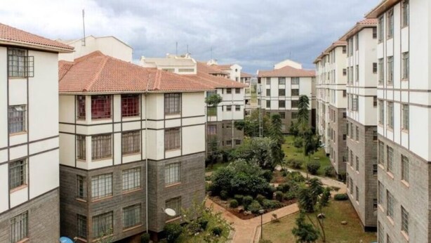 A residential building with multiple floors, a courtyard with greenery, and a tiled roof. - The colored house 3 bedroom apartment (Athiriver)