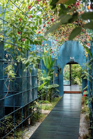 A greenhouse with a pathway leading to a door labeled "OUTSIDE." - AnNam Village 1 (Vũng Tàu)