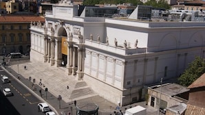 A large, classical building with a central staircase and statues on the upper level. - Esposizione Luxury Rome (Rome)