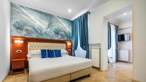 A bedroom with a large bed, a marble wall, and a television mounted on the wall. - Esposizione Luxury Rome (Rome)