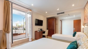 A hotel room with a large bed, a desk with a chair, a television, and a wardrobe. - Esposizione Luxury Rome (Rome)