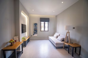 Luxury Suite, Balcony, City View | Living area | 55-inch Smart TV with digital channels