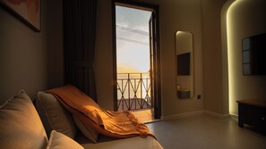 Luxury Suite, 1 King Bed with Sofa bed, Balcony, Beach View | Living area | 55-inch Smart TV with digital channels - Tramonto Phu Quoc Hotel (Phu Quoc)
