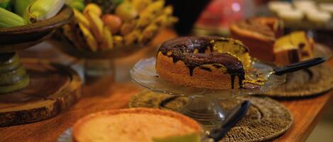A buffet with various desserts and fruits.