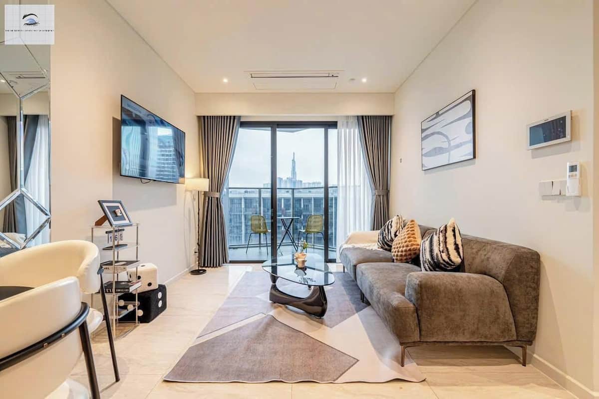 Deluxe Apartment, 2 Bedrooms, Patio | Living area | 24-inch TV with cable channels, books, music library