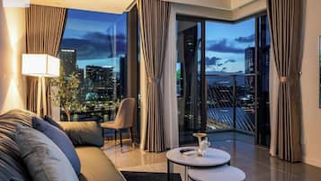 Deluxe Apartment, 2 Bedrooms, Patio | Living area | 24-inch TV with cable channels, books, music library