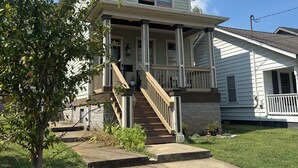 A two-story house with a front porch, a staircase, and a small front yard. - Bright & Airy 2-bed, 2.5-bath house in historic Germantown, Nashville (Nashville)
